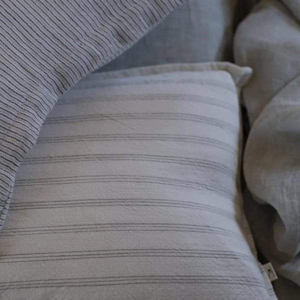 Meraki linen cotton cushion cover styled on bed